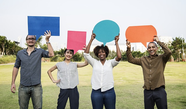 Four People Having Shaped Talk Boxes in their Hands